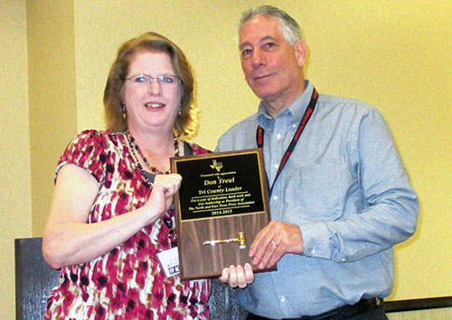 Susan Reeves (left) passing the gavel to incoming Chairman of the Board Don Treul on Saturday.